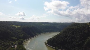 Video from a drone flying above the Rhine river in Germany, visible road on both sides of the river.