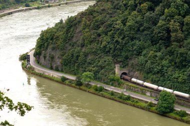 Batı Almanya 'da Ren nehri orman, görünür yük treni ve gemiler için trafik ışıklarıyla kaplı tepeler arasında akar..