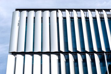 Modern bir binanın ön cephesi. Otomatik, hareketli perdelerden yapılmış yenilikçi bir cephe..