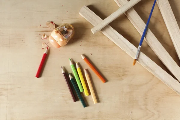 Colored pencils on a wooden board — Stock Photo, Image