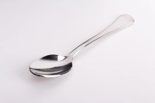 Stainless steel kitchen dessert spoon isolated over the white background — Stock Photo, Image