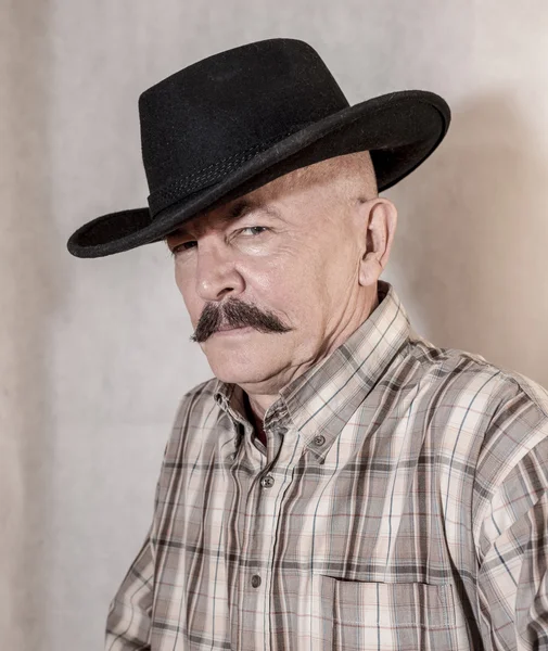 The cowboy with mustache, in a black hat — Stock Photo, Image