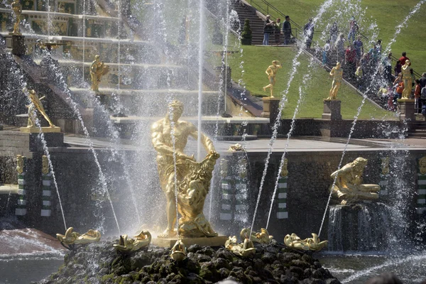 Tourists admire the fountain"Samson tearing the lion's mouth." — Stock Photo, Image