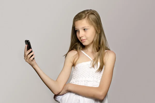 Young girl taking a selfie, kid taking a photo herself and having fun — Stock Photo, Image