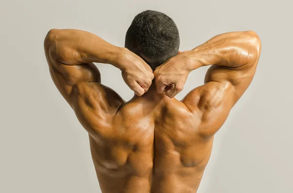 Bodybuilder showing his back,shoulders, triceps and biceps muscles, personal fitness trainer — Stock Photo, Image