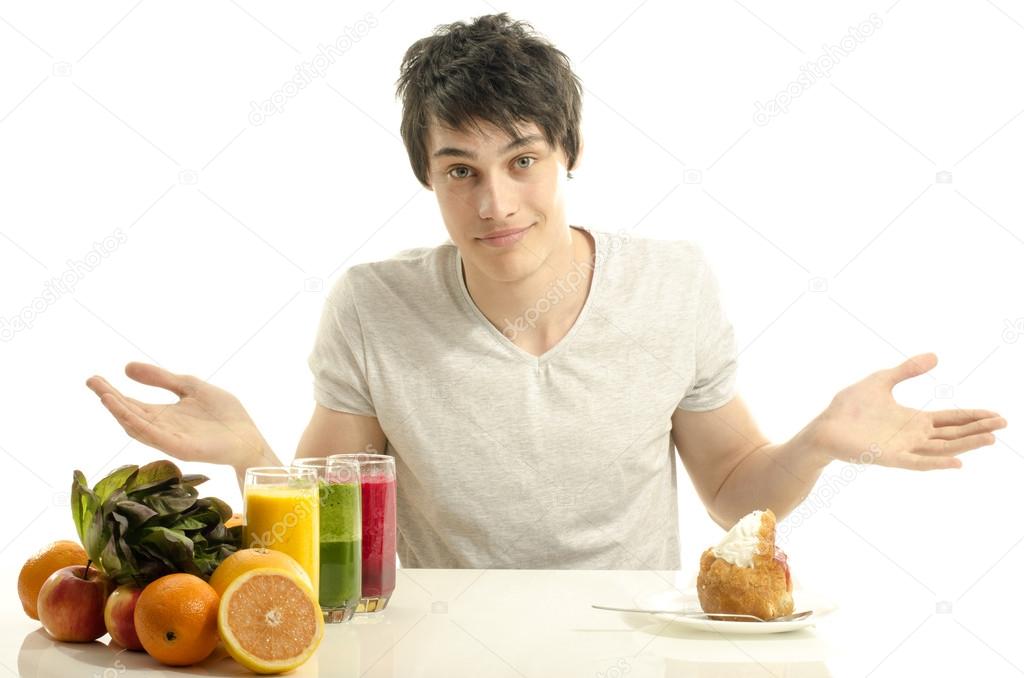 Man choosing between fruits, smoothie,salad and organic healthy food against sweets, sugar, lots of candies