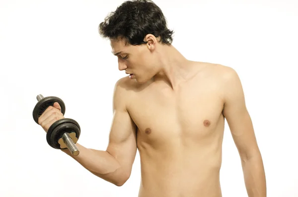 Hombre flaco entrenando su músculo bíceps. Hermosa adolescente levantando una dumbbell.Anorexic joven entrenamiento para ser más fuerte —  Fotos de Stock