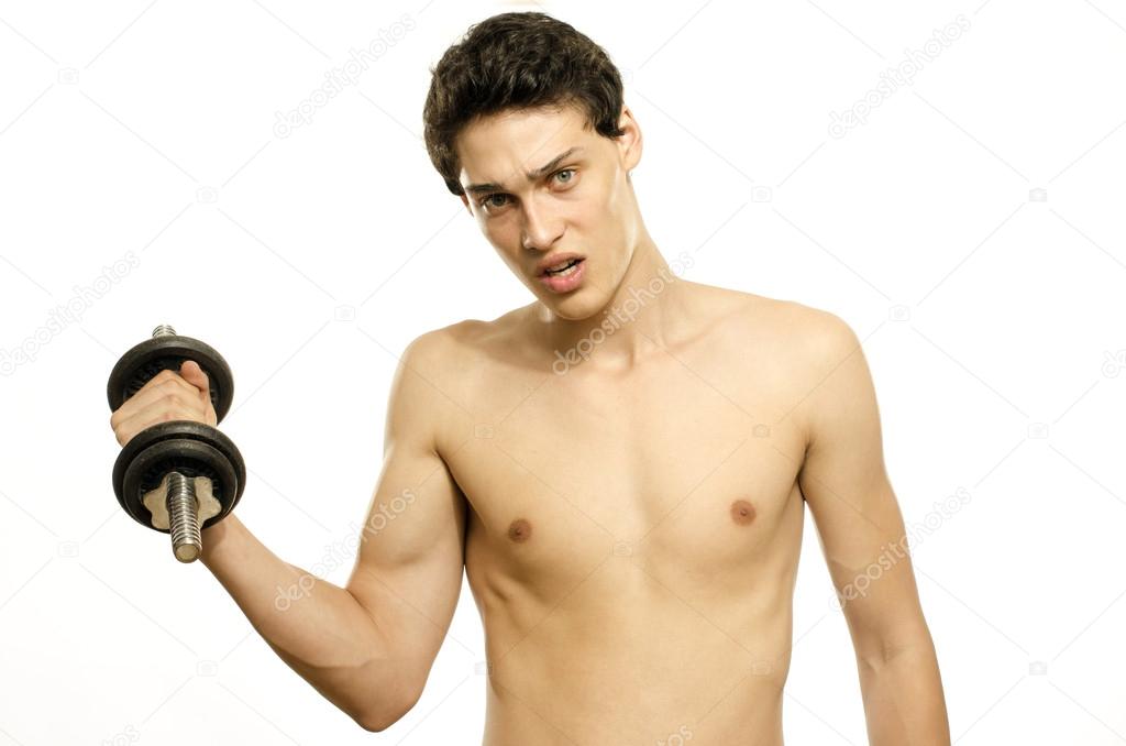 Skinny man training his bicep muscle. Beautiful teenager lifting a