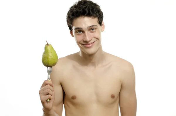 Young man choosing to eat an organic, healthy pear for a perfect diet — Stock Photo, Image