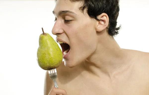 Young man choosing to eat an organic, healthy pear for a perfect diet — Stock Photo, Image