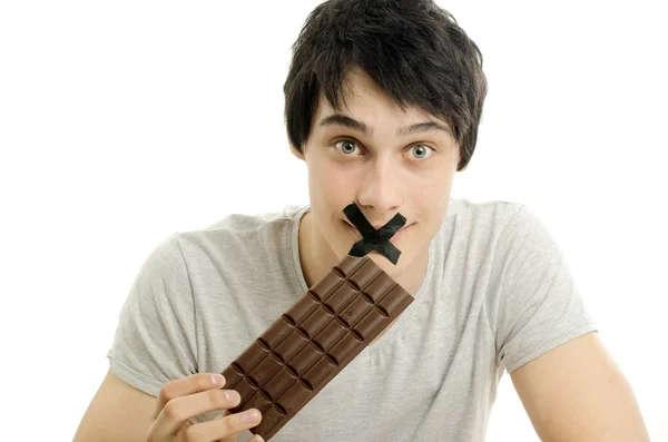 Hombre feliz comiendo un delicioso chocolate y teniendo un poco de azúcar para un día activo — Foto de Stock