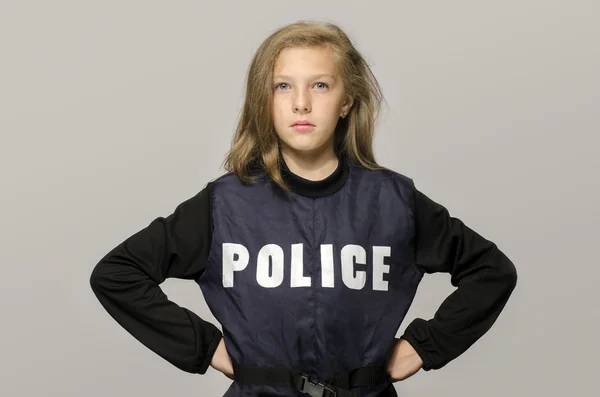 Little blonde girl saying stop to domestic violence. Kid wearing a police jacket upset protesting against parents brutality — Stock Photo, Image