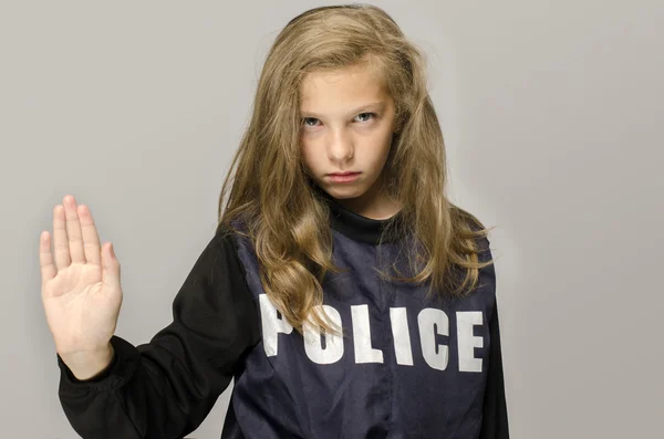 Little blonde girl saying stop to domestic violence. Kid wearing a police jacket upset protesting against parents brutality — Stock Photo, Image