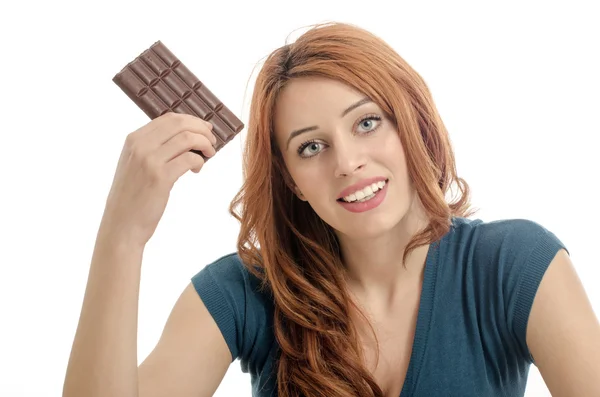 Happy woman eating a yummy chocolate and having some sugar for an active day, chocolate addiction — Stock Photo, Image