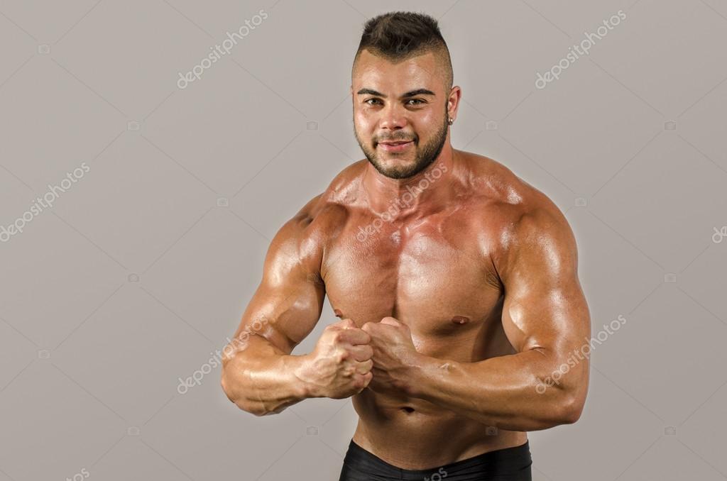 https://st2.depositphotos.com/1726139/6828/i/950/depositphotos_68289813-stock-photo-bodybuilder-topless-flexing-his-biceps.jpg