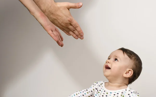 O pai a alcançar o seu lindo bebé. Recém-nascido feliz por ver seu pai tentando proteger e mostrar-lhe amor — Fotografia de Stock