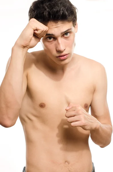 Young man training in martial arts, boxing, jiu jitsu and mma. Beautiful guy punching — Stock Photo, Image