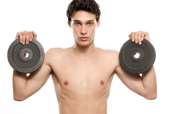 Hombre flaco entrenando su músculo bíceps. Hermosa adolescente levantando dos dumbbells.Anorexic joven entrenamiento para ser más fuerte —  Fotos de Stock