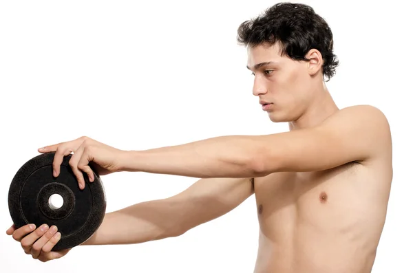 Hombre flaco entrenando su músculo bíceps. Hermosa adolescente levantando una dumbbell.Anorexic joven entrenamiento para ser más fuerte — Foto de Stock