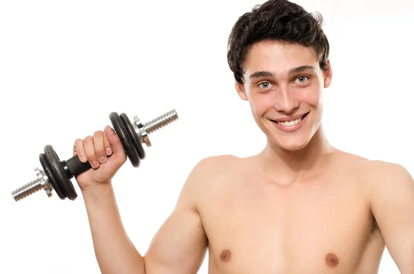 Hombre flaco entrenando su músculo bíceps. Hermosa adolescente levantando una dumbbell.Anorexic joven entrenamiento para ser más fuerte —  Fotos de Stock