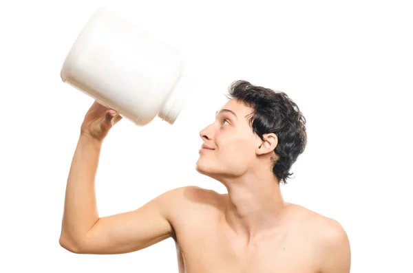Skinny man training and drinking a protein shake. Anorexic young man training to become stronger and using steroids — Stock Photo, Image