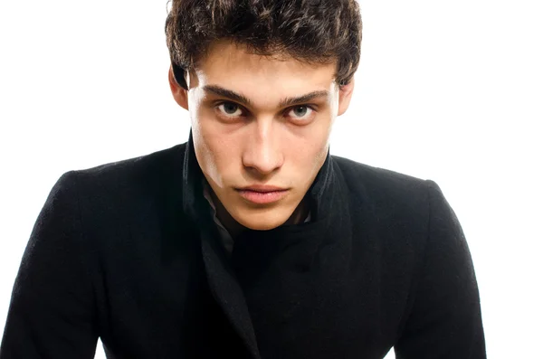 Portrait of a beautiful young man dressed in a black long coat, angry and stressed — Stock Photo, Image