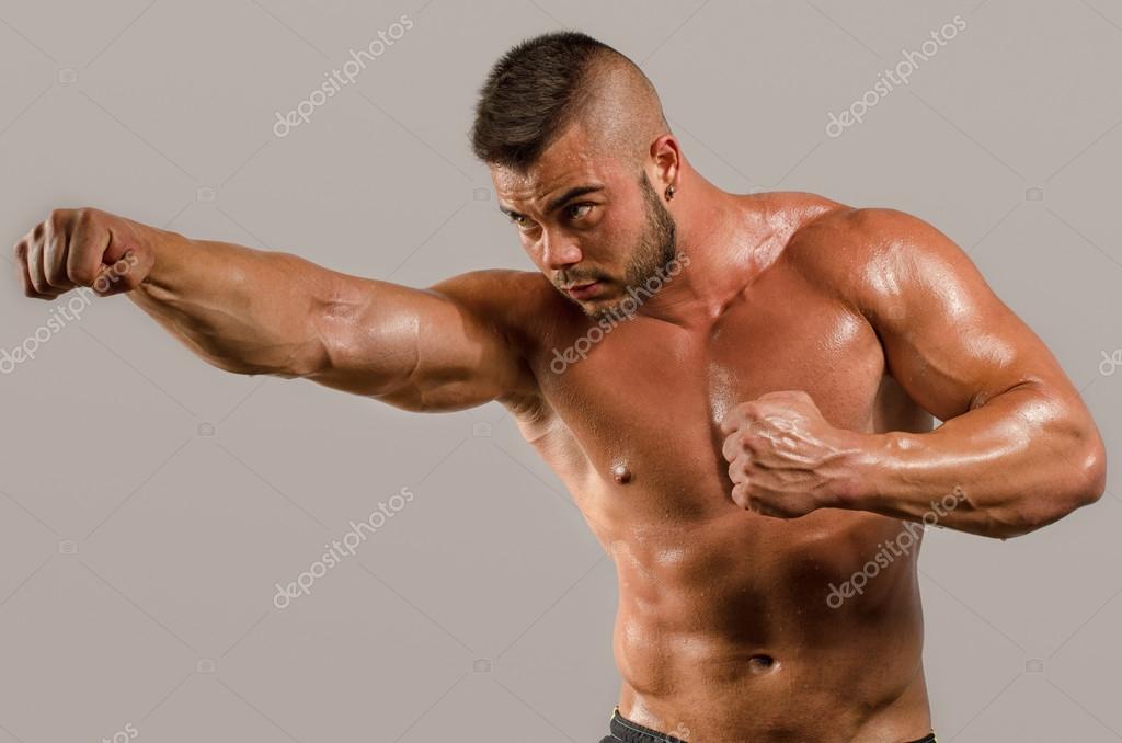 Strong bodybuilder man with perfect abs, shoulders,biceps, triceps and
