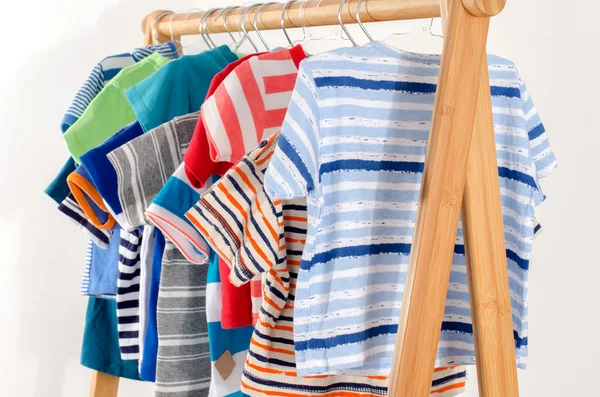 Разноцветный гардероб новорожденного, детей, малышей, младенцев, полных всей одежды. Многие футболки, брюки, рубашки, блузки, ползунки висит — стоковое фото