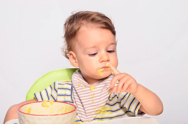 Baby eating food with a spoon, toddler eating messy and getting — Stock Photo, Image