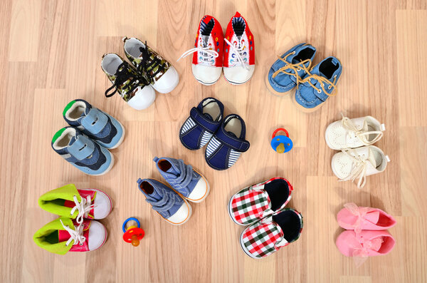 Baby shoes arranged on the floor.