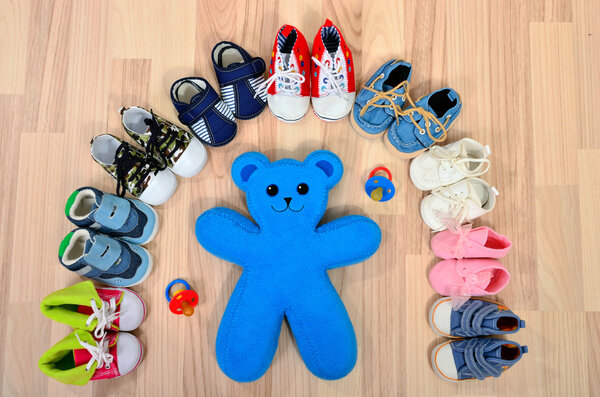 Baby shoes arranged in a line.