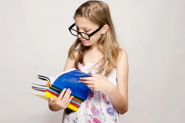 Little girl with eyeglasses reading some books, kid learning, ch — Stock Photo, Image
