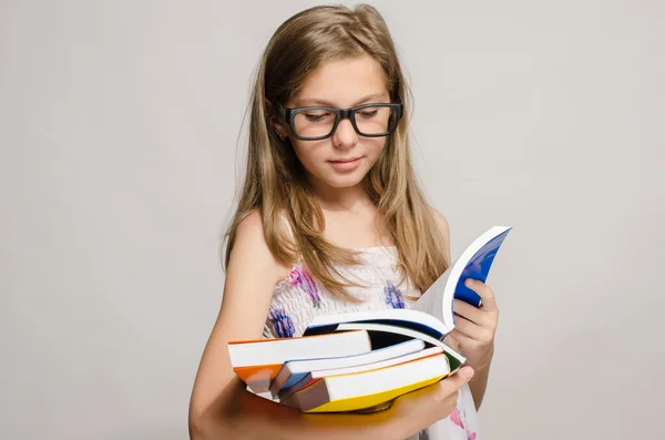 Little girl with eyeglasses reading some books, kid learning, ch — Stock Photo, Image