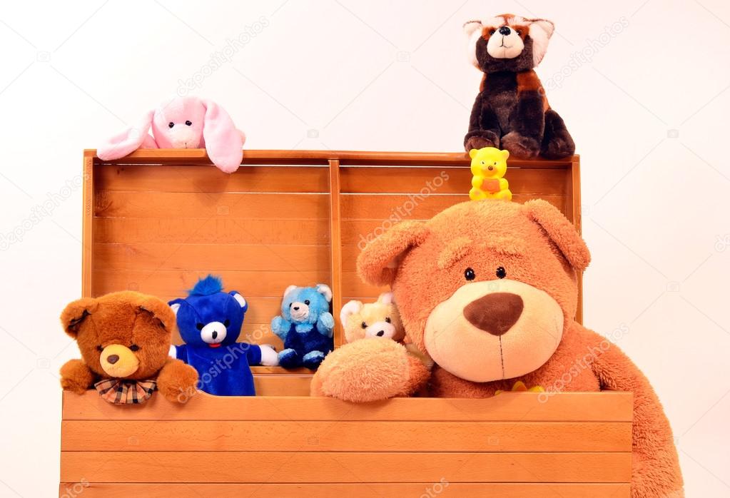 Child trunk with a big teddy bear and small plush toys.