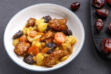 Bir tabak yahudi mutfağı, içinde vejetaryen hurma, havuç ve şeker dolu meyveler var.