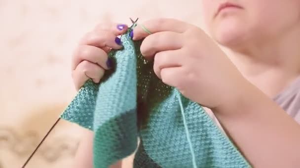 Breinaalden in de handen van vrouwen breien een trui van lichte wol. — Stockvideo