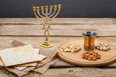 Matzah ve fındıklı yuvarlak bir tahta masa ve bir bardak kiraz şarabı..