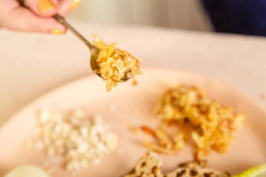 Haroset of apples and nuts for seder pesach in a spoon in a womans hand.