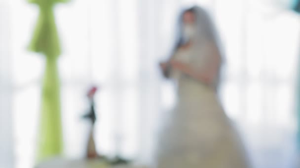 Eine jüdische Braut in Hochzeitskleid und Schleier mit medizinischer Maske zieht elegante weiße Handschuhe an. Von Unschärfe zu Schärfe — Stockvideo