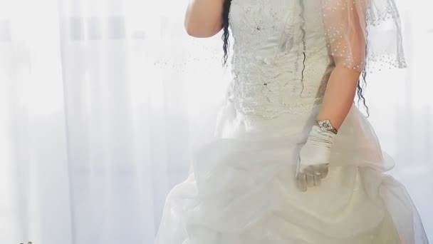 結婚式のドレスを着たユダヤ人の花嫁と礼拝堂の医療マスクを着たベールは スマートフォンで話す前に 中期計画 — ストック動画