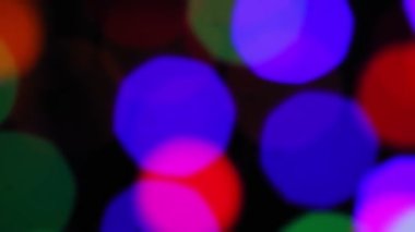 Siyah arkaplanda Bokeh bulanıklığı. Siyah arkaplanda çok renkli ışınlar.