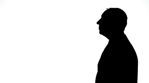 Silhouette d'un homme de profil sur fond blanc — Video