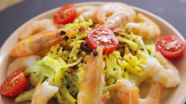 Kremalı soslu makarna, tabakta karidesler daire şeklinde döner.