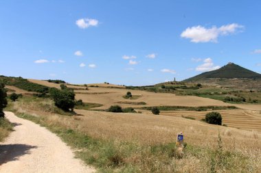 Camino de Santiago İspanya Temmuz 2024 arkasında Monjardin dağı ve kalesi ile işaret ve kabuk sembolü