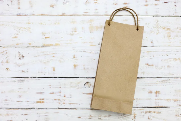 Paper bag on a wooden texture background — Stock Photo, Image