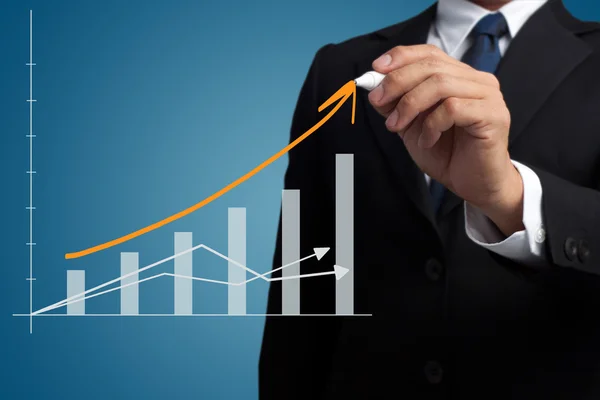 Business man drawing a growing graph — Stock Photo, Image