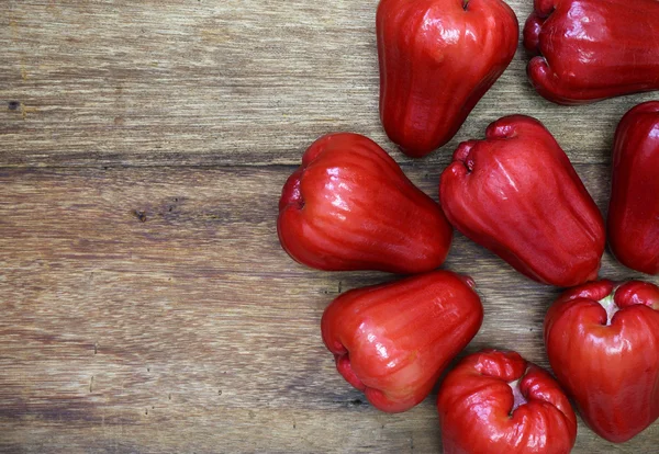 Red rose apple on wood background — Stock Photo, Image