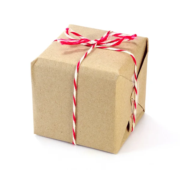 Brown paper parcel tied with red and white string on white backg — Stock Photo, Image