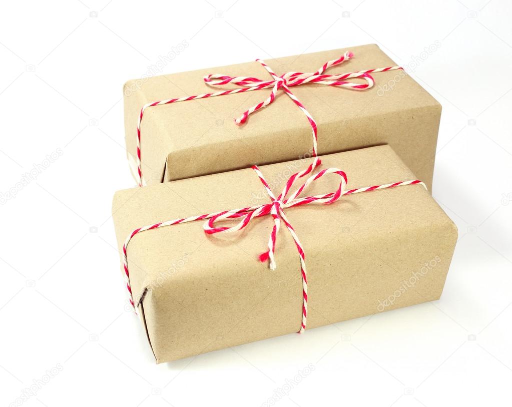 brown paper parcel tied with red and white string on white backg