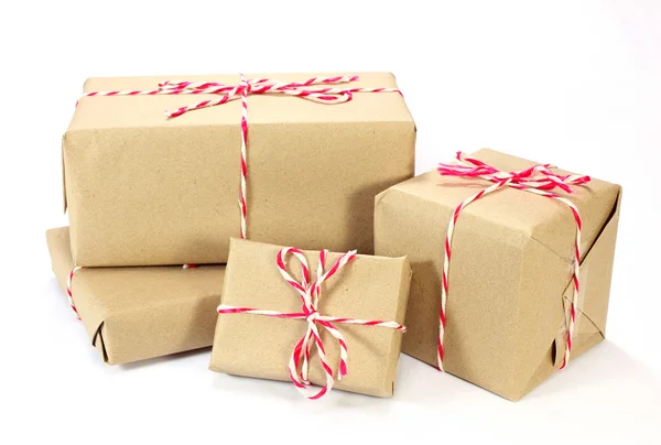 Brown paper parcel tied with red and white string on white backg — Stock Photo, Image